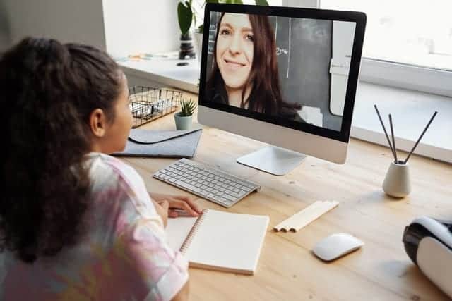 Girl staring at a computer screen with a private tutor
