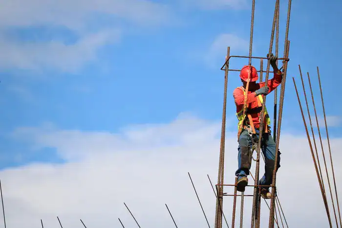 A builder strapping down steel ready for building a new home.