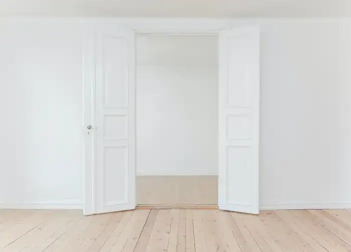A new home with white doors that are open and white walls.