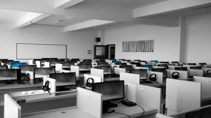 New computers in a sales office with telesales cubicles and headsets,