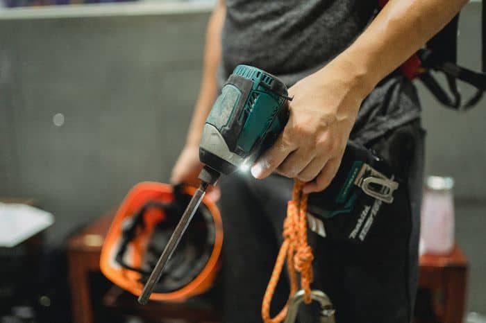 Tradesman holding an electric saw.