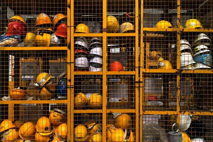 Cages of worksite helmets stacked up.