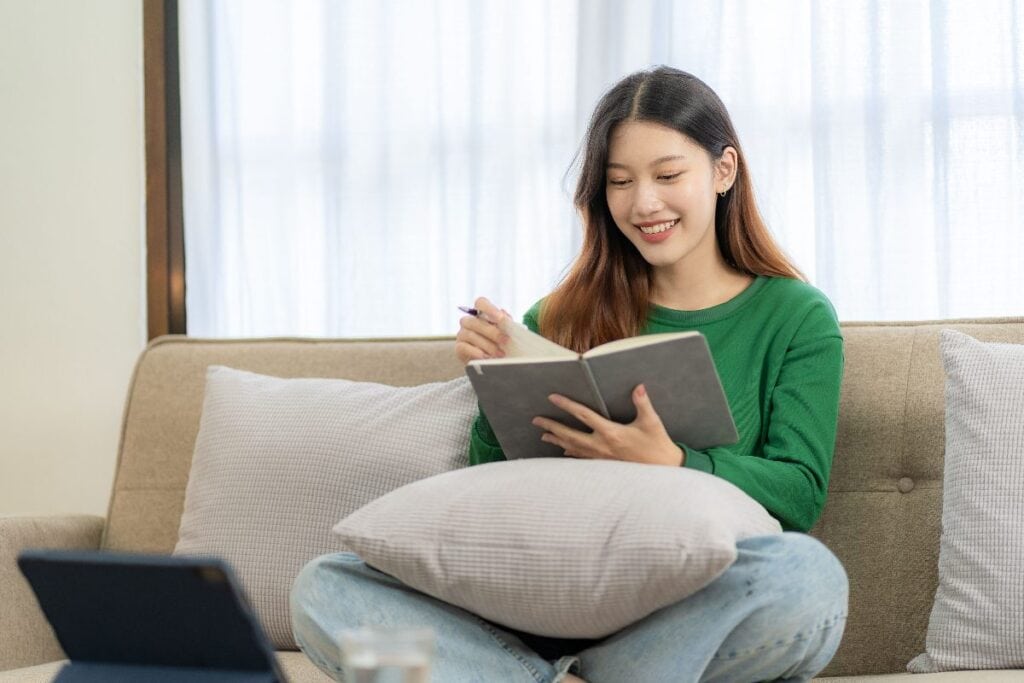 Person reflecting on goals and motivation in a notebook.
