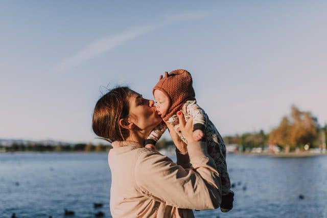 Woman lifting up a newborn baby