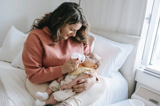 Woman feeding a newborn baby