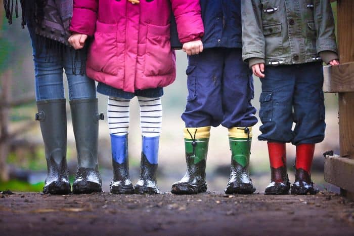 Children wearing wellies stood in a line ready for adventure and a unique hobby.