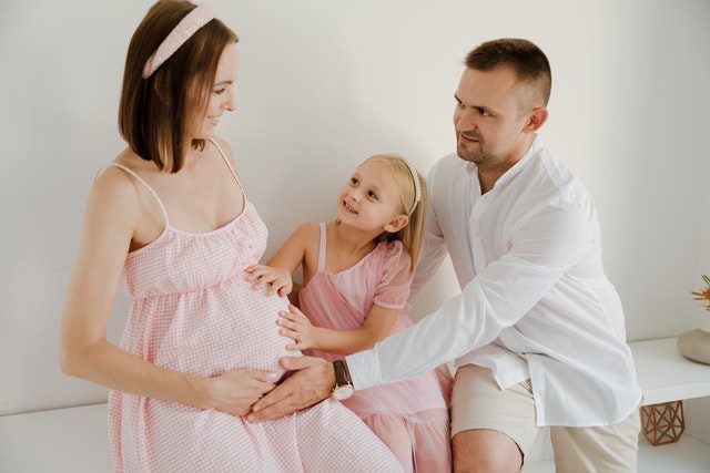 A family celebrating a second pregnancy