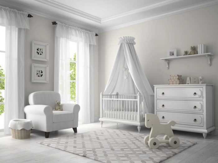 A beautifully designed nursery featuring soft white furniture, including a cushioned armchair, crib with a canopy, and a dresser with delicate details. The room is accented with plush toys, a rocking horse and minimalist decor, creating a serene and stylish space for a baby.