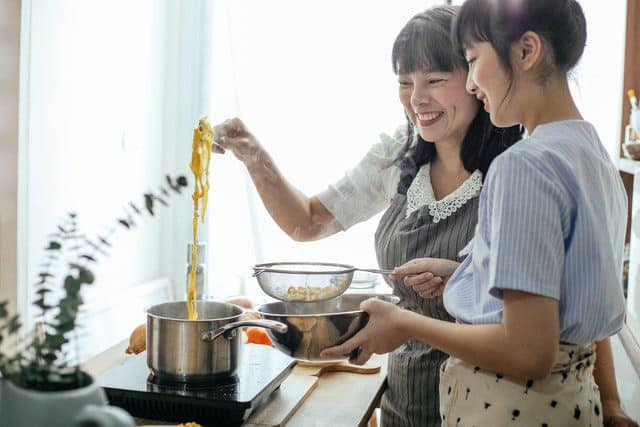 mother and daughter cooking
