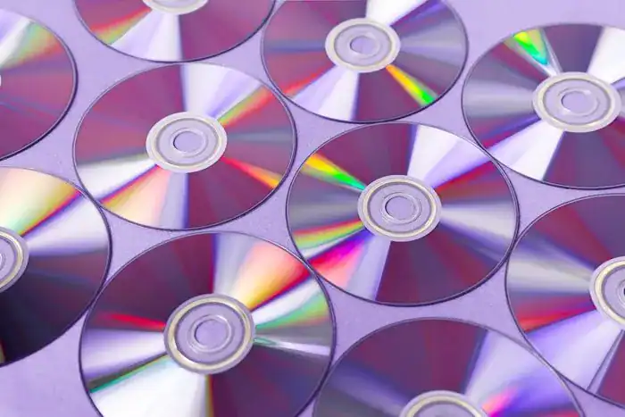 A pile of shiny DVDs for photo storage.