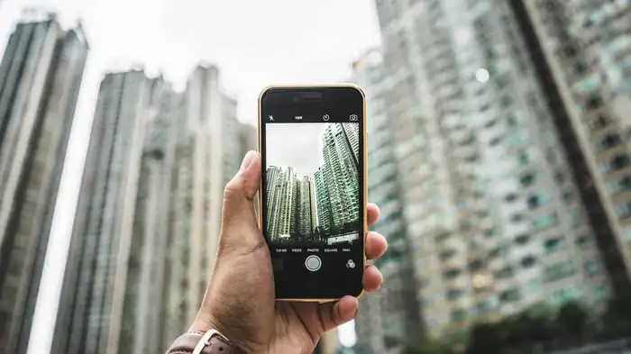 Taking a picture of large buildings on a mobile phone.