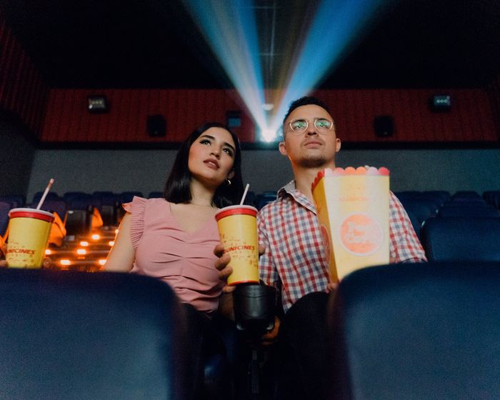 coupe sat in a cinema with popcorn and drinks