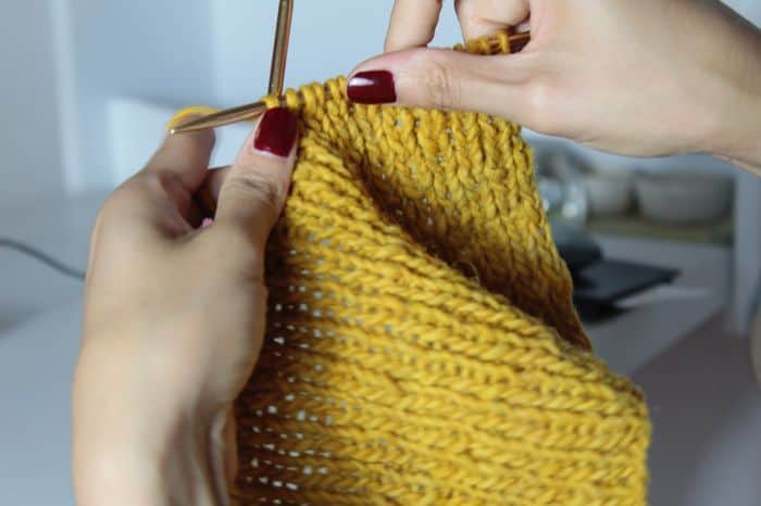 woman knitting to sell and make money