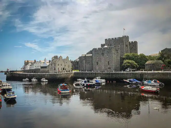 A castle by a port in the Isle of Man.