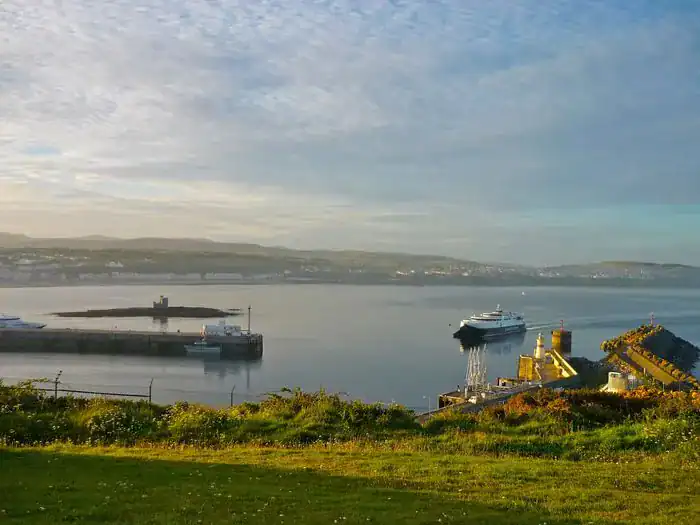 Coastal views of the Isle of Man with a ferry coming into the port.