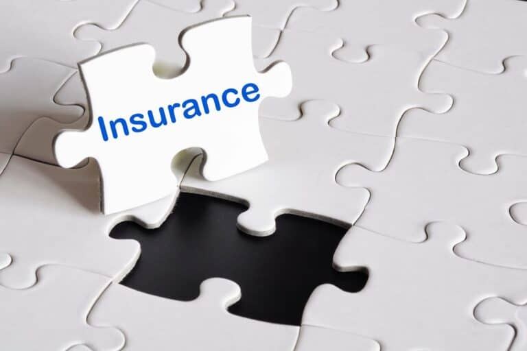 A puzzle piece labelled 'Insurance' being placed into a missing slot, symbolising the importance of understanding Types Of Small Business Insurance.