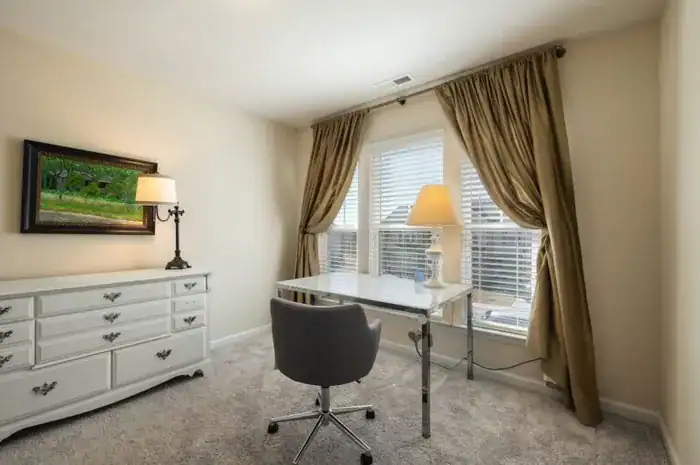 A room with curtains and blinds.