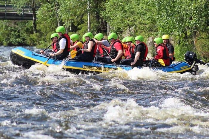 People whitewater rafting enjoying a holiday without going abroad.