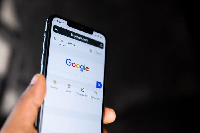 University student using Google to find answers on a phone.