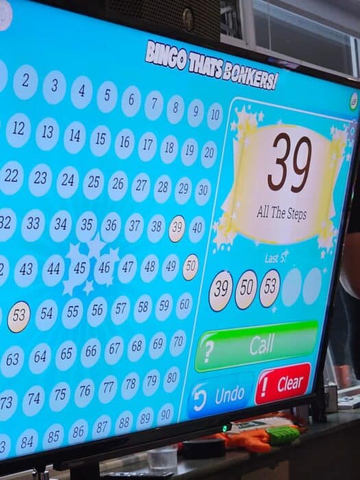 TV screen showing bingo numbers being called.