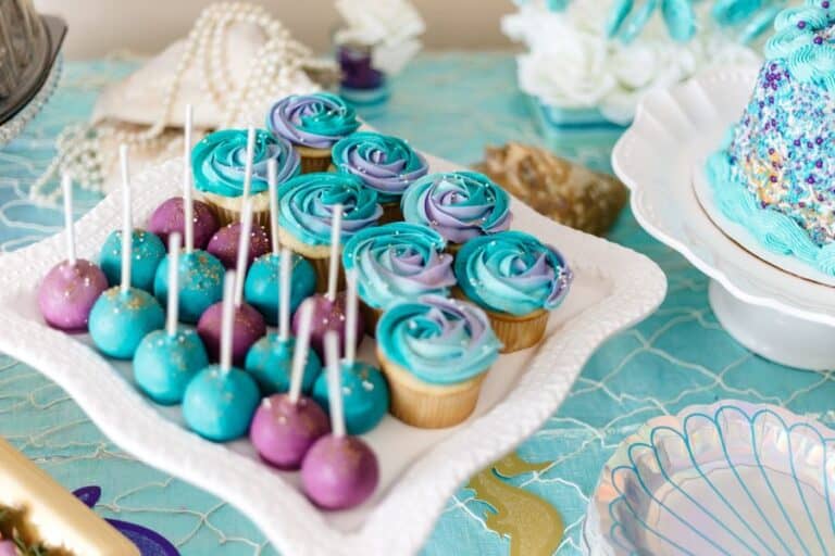 Blue and purple icing cupcake and cake pop for baby shower decorating ideas.