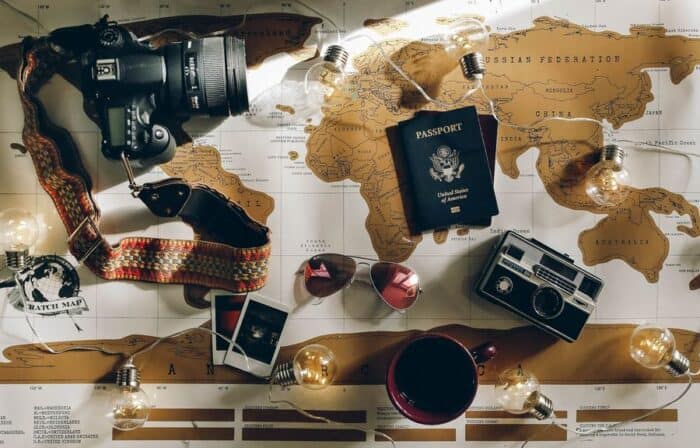 Passport and travel effects placed on a map to highlight the importance of holiday insurance.