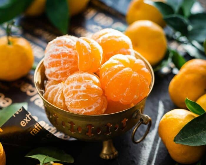 Bowl of peeled oranges for healthy you and healthy hair.