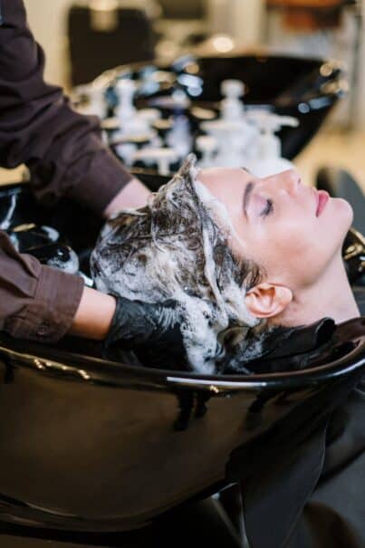 Woman having hair shampooed in a hair salon.