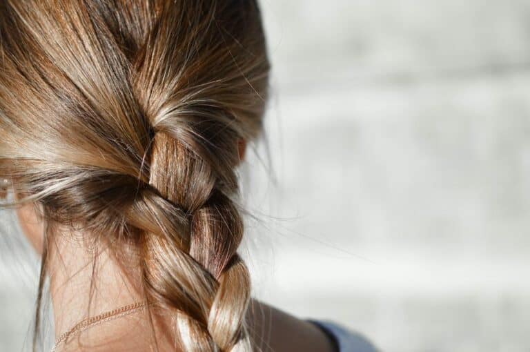 Woman with a plait in her hair, following tips for a good haircare routine.