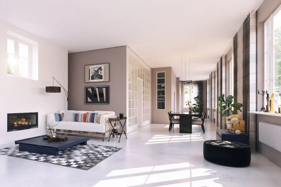 Elegant open-plan living and dining room with neutral sofa, low coffee table, patterned rug and large windows - elegant home interior design.