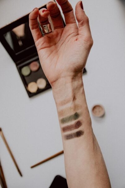 Espresso makeup in a range of brown shades swiped on someone's arm to check colours, following the latest beauty trends.