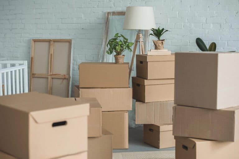 Cardboard moving boxes stacked in a family home before moving house in the UK