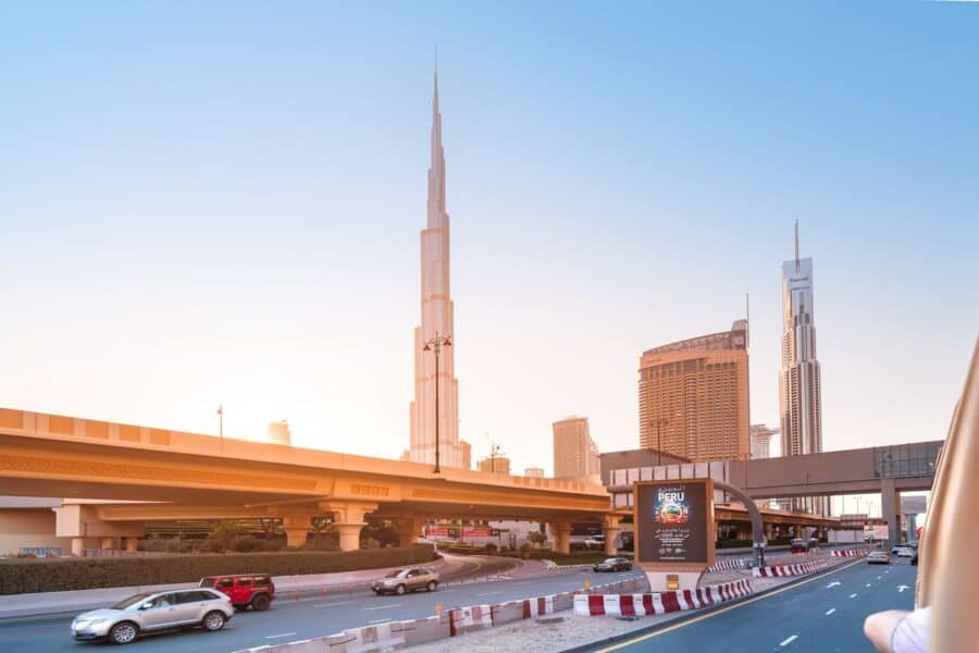 Dubai skyline with the Burj Khalifa and a highway, a perfect backdrop for renting a car in Dubai to explore the city.