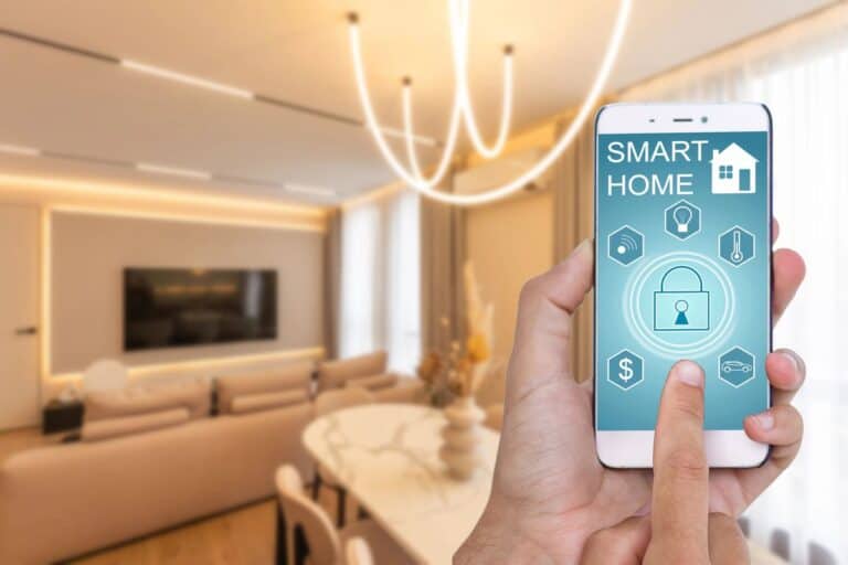 Person controlling smart home security and lighting with a smartphone app, highlighting smart electrical upgrades for a modern, energy-efficient living room.
