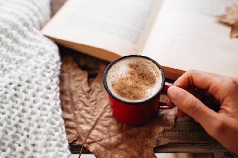 Cosy morning moment with coffee and book, reflecting quick morning habits for an instant mood boost