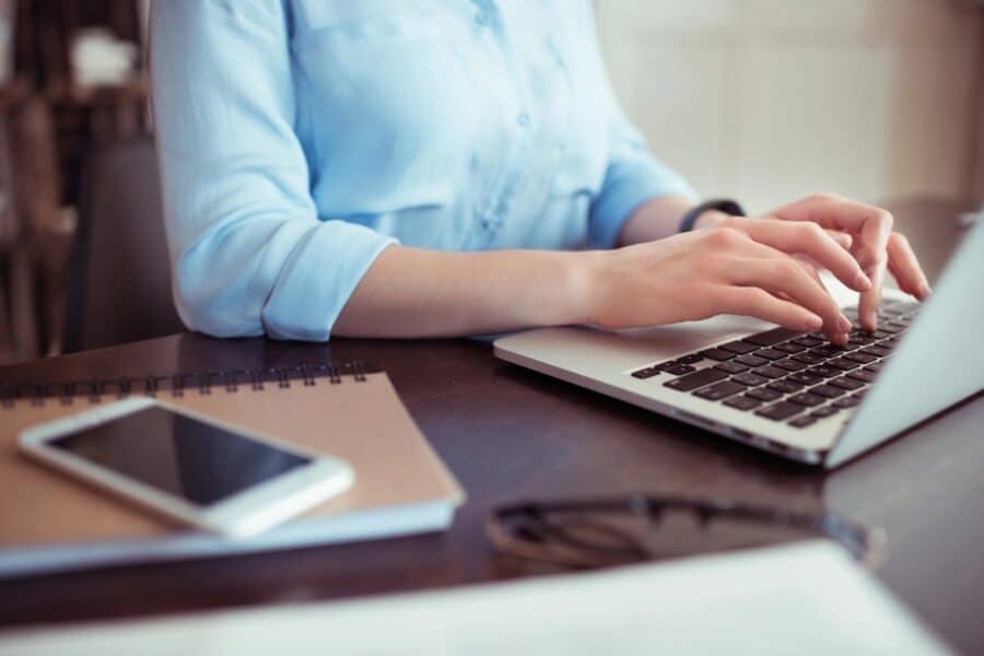Small business owner working securely on a laptop, highlighting the importance of protecting business email and customer data online.