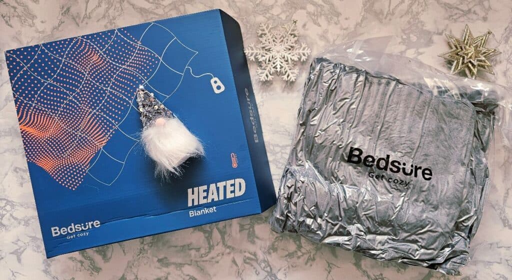 Bedsure heated blanket gift set (box and blanket) on a festive flat lay – cosy gift inspiration for grandparents.