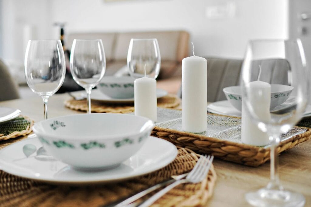 Celebration culture at home: simple dinner table ritual with candles and place settings
