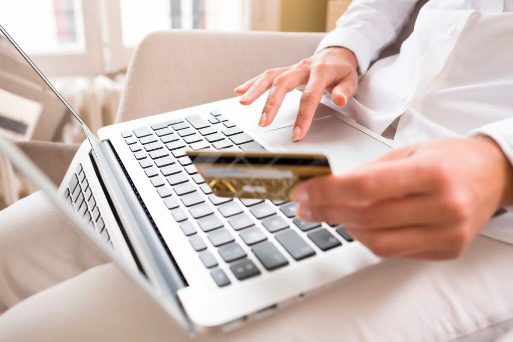 Save money shopping online in the UK with a shopper paying by card on a laptop