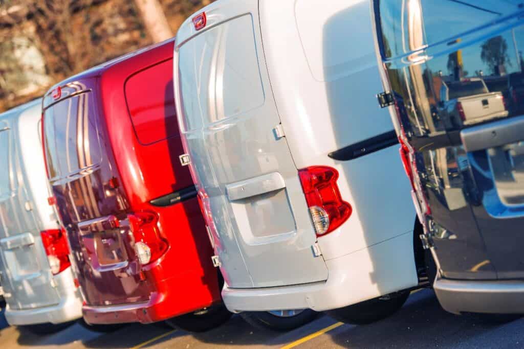 Multiple business vans lined up in a car park, showing small business fleet cover.