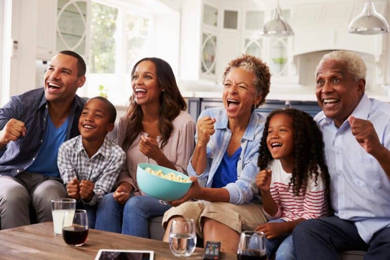 Family tradition at home with three generations sitting together and enjoying time in the living room.