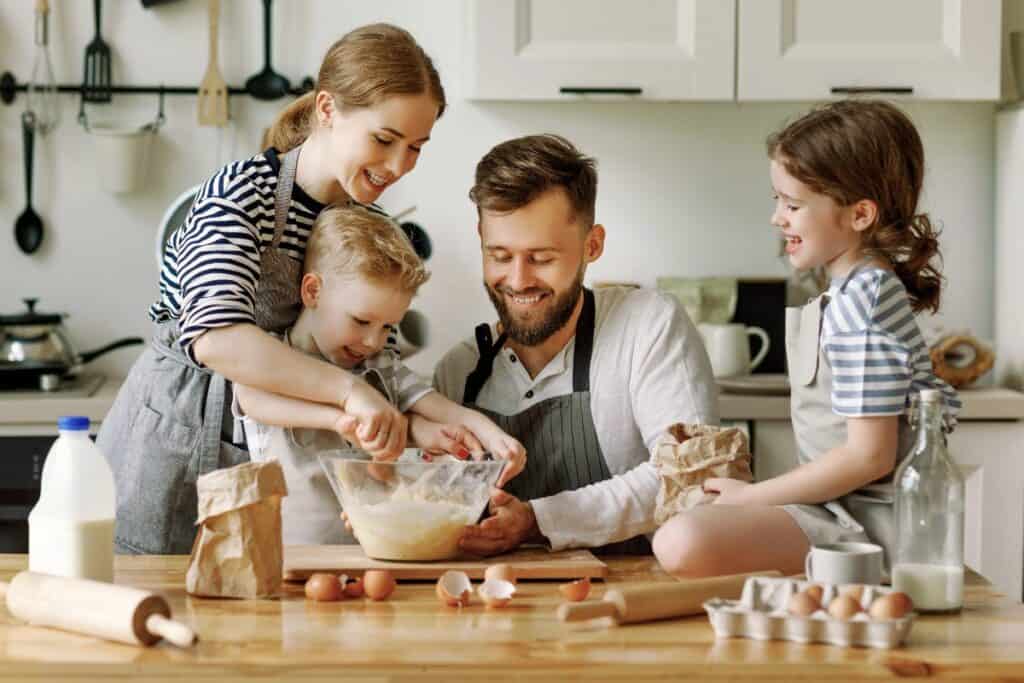 Family baking together in the kitchen as part of a simple family tradition at home.