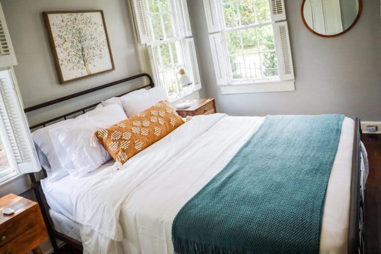 Bedroom layout mistakes in a bright bedroom with large bed, bedside tables and natural light