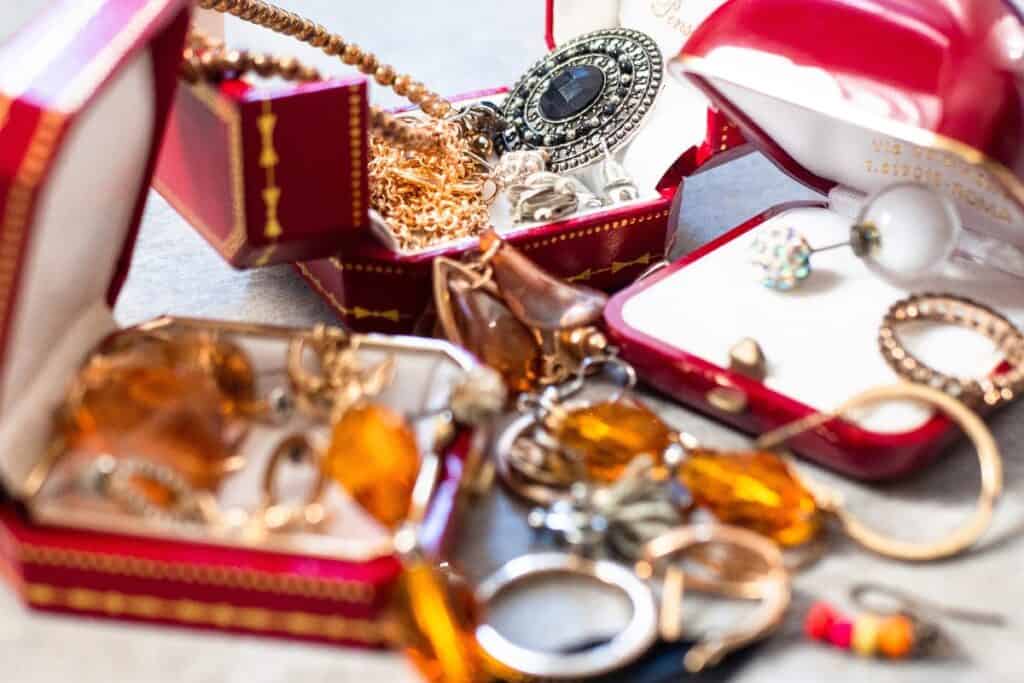Vintage jewellery and heirloom pieces in red ring boxes and small keepsake cases.