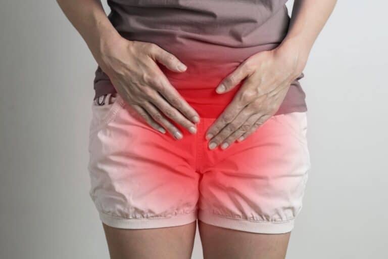 Person holding their lower abdomen to show possible UTI discomfort.