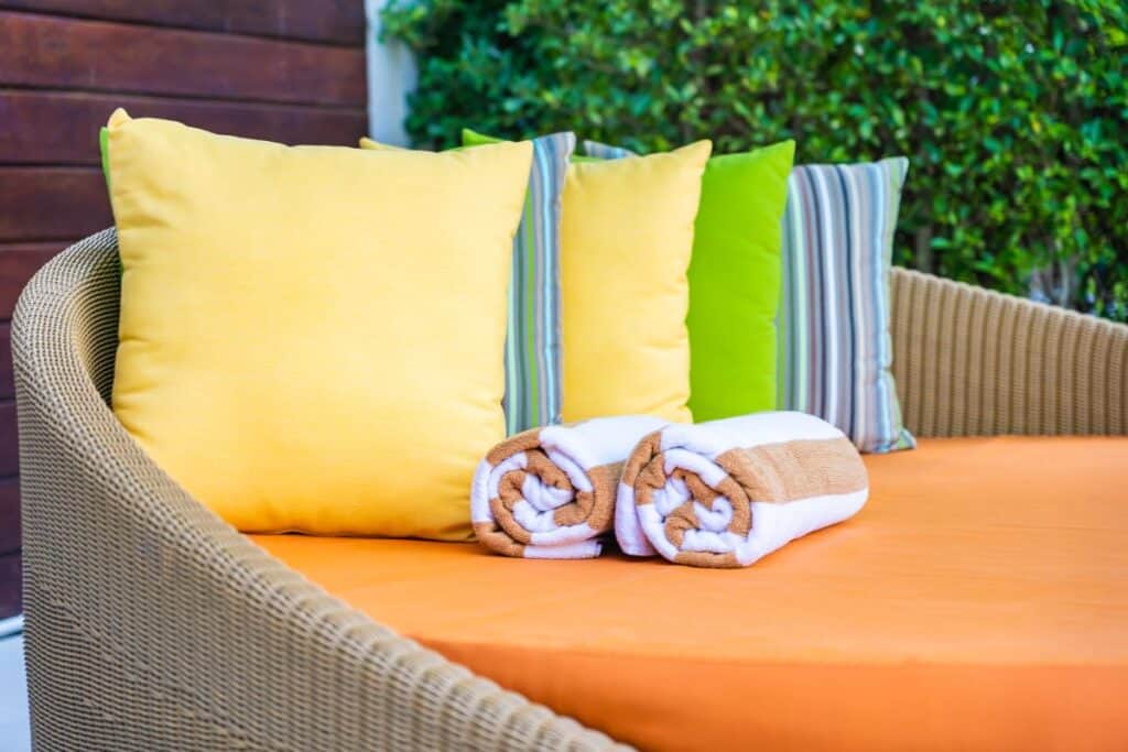 Colourful outdoor cushions on garden seating for a practical patio project.