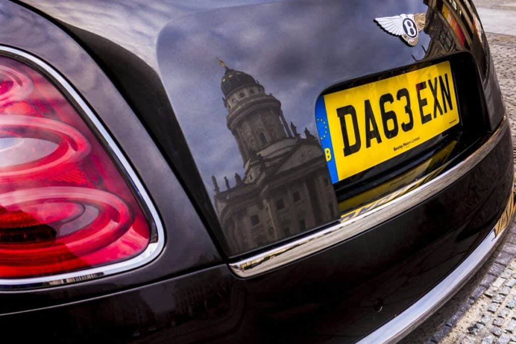Rear number plate on a car parked on a UK street.