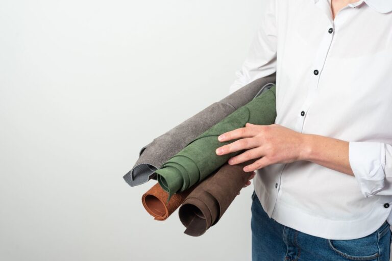 Person holding rolls of fabric for a practical home or garden project.