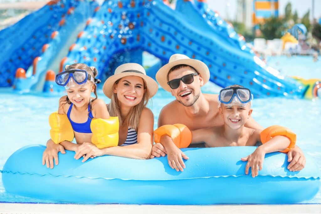 Family enjoying a water park on holiday abroad with children.