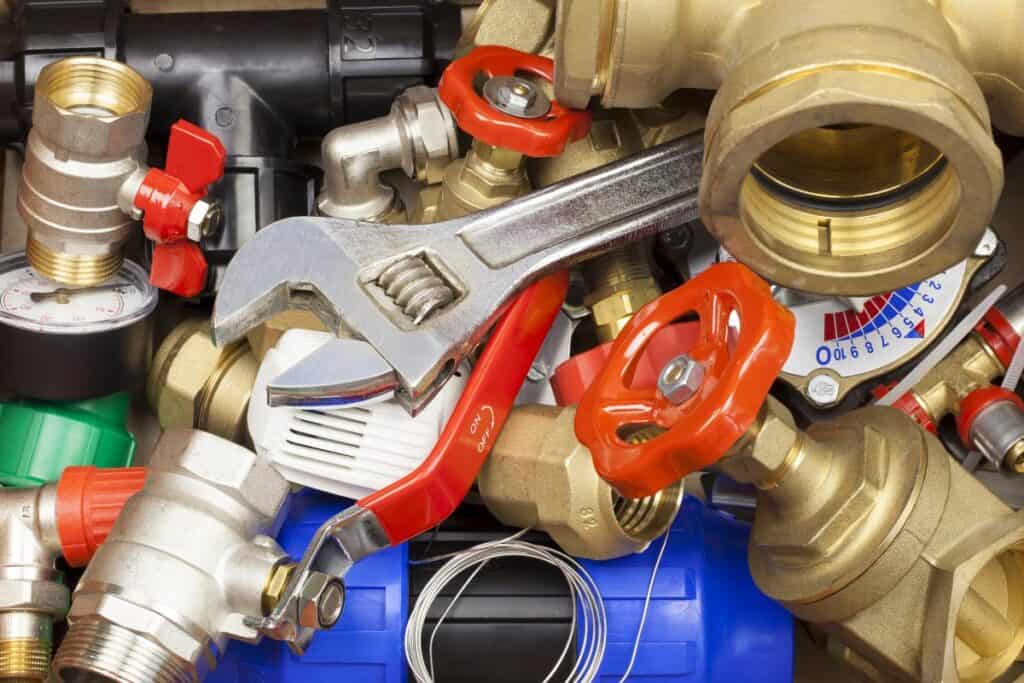 Plumbing parts, valves and fittings with an adjustable wrench.